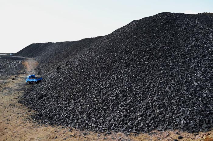 Workers sort coal near a coal mine in Datong, China's northern Shanxi province on November 2, 2021. (Photo by Noel Celis / AFP) (Photo by NOEL CELIS/AFP via Getty Images)